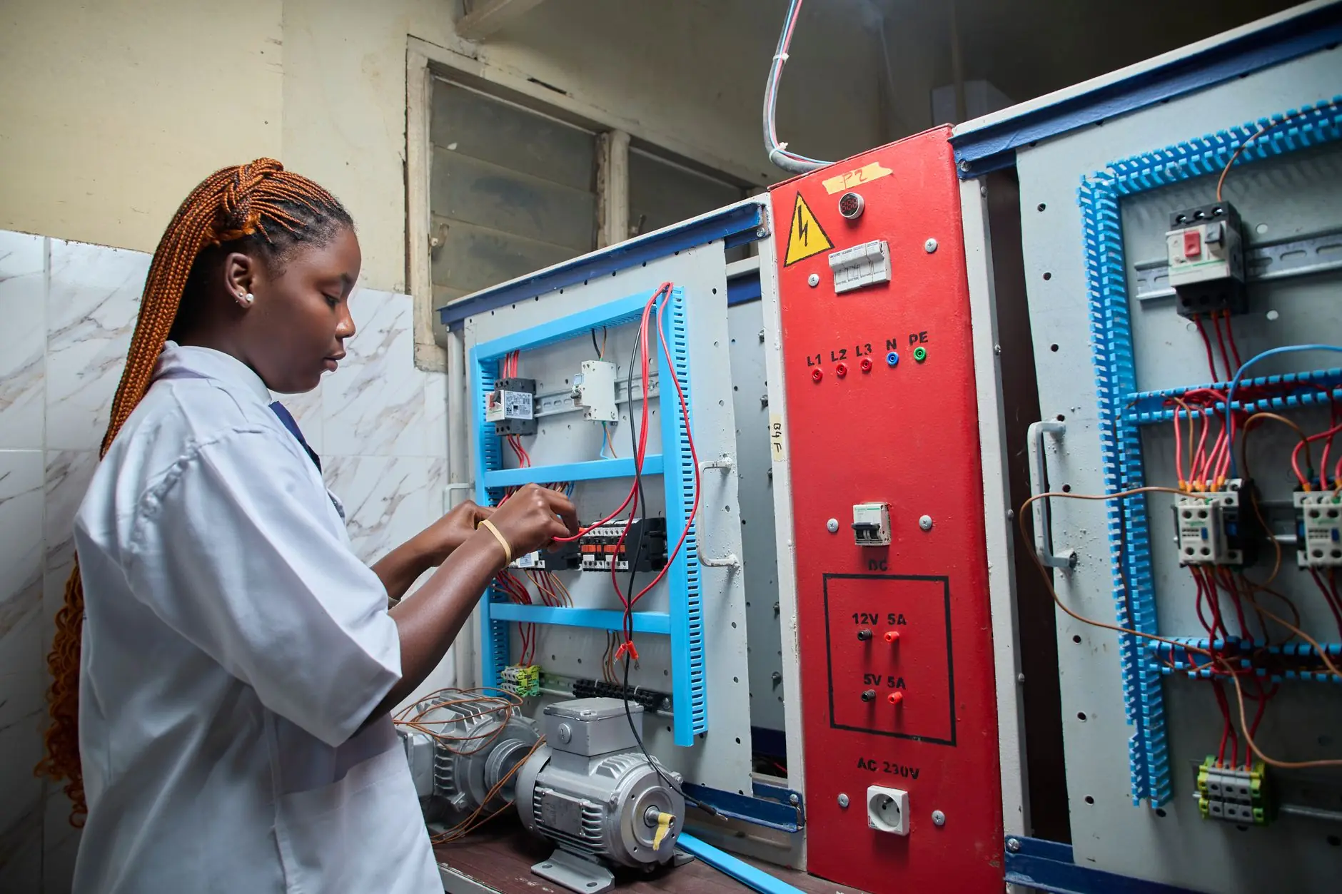 Technician working on an electrical control panel